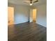 Cozy bedroom featuring new floors and a ceiling fan, next to a bathroom with toilet at 4706 Piney Grove Rd, Cumming, GA 30040