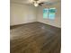 Bright bedroom with new floors, ceiling fan and large windows, offering ample natural light at 4706 Piney Grove Rd, Cumming, GA 30040