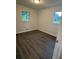 Bedroom with hardwood floors and natural light from two windows at 4706 Piney Grove Rd, Cumming, GA 30040
