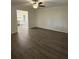 Bright living room with new flooring, neutral paint and ceiling fan fixture at 4706 Piney Grove Rd, Cumming, GA 30040