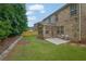 A well-maintained backyard features a tile patio and green lawn at 7027 Walham Grv, Duluth, GA 30097