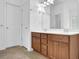 Bathroom featuring a double vanity with wood cabinets, white countertops, and updated fixtures at 7027 Walham Grv, Duluth, GA 30097