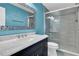 Bathroom featuring a granite countertop, decorative mirror, and glass-enclosed shower at 7027 Walham Grv, Duluth, GA 30097