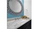 Elegant bathroom with marble countertops, a unique decorative mirror and modern fixtures at 7027 Walham Grv, Duluth, GA 30097