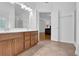 Bright bathroom with double vanity and an open doorway leading to bedroom at 7027 Walham Grv, Duluth, GA 30097