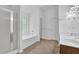 Well-lit bathroom with a glass-enclosed shower, soaking tub, and a double vanity at 7027 Walham Grv, Duluth, GA 30097
