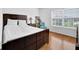 Bright bedroom with hardwood floors, large window and dark wood bed at 7027 Walham Grv, Duluth, GA 30097