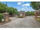 Secured gated entrance to the community with brick pillars and security features at 7027 Walham Grv, Duluth, GA 30097
