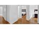 Hallway with hardwood floors leading to a bedroom and other rooms at 7027 Walham Grv, Duluth, GA 30097