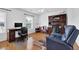 Spacious home office with hardwood floors, ceiling fan, natural light, and comfortable seating area at 7027 Walham Grv, Duluth, GA 30097
