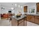 Open kitchen with wooden island, stainless appliances, and a connection to the dining area, perfect for entertaining guests at 7027 Walham Grv, Duluth, GA 30097