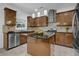 Modern kitchen with wood cabinets, a center island, stainless steel appliances and a backsplash, offering style and functionality at 7027 Walham Grv, Duluth, GA 30097