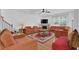 Large living room with a fireplace, hardwood floors, and comfortable couches at 7027 Walham Grv, Duluth, GA 30097