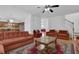 Open-concept living room, hardwood floors, comfortable sofas, and seamless flow to the kitchen at 7027 Walham Grv, Duluth, GA 30097
