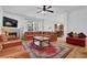 Open floor plan living room with fireplace, hardwood floors, and plenty of natural light at 7027 Walham Grv, Duluth, GA 30097