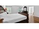 Spacious main bedroom featuring hardwood floors, neutral walls, and large windows at 7027 Walham Grv, Duluth, GA 30097