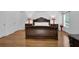 Primary bedroom featuring hardwood floors, neutral walls, and elegant dark wood furnishings at 7027 Walham Grv, Duluth, GA 30097