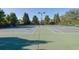 Outdoor tennis courts with green surface and nets at 7027 Walham Grv, Duluth, GA 30097