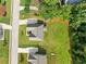 An aerial view of a home with a well-manicured lawn, a driveway, and mature trees surrounding the property at 110 Collingwood Lndg, Covington, GA 30016