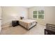 Cozy bedroom with a twin bed, side table, lamp, and window with blind offering outdoor views at 110 Collingwood Lndg, Covington, GA 30016