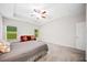 Spacious bedroom with carpet, tray ceiling, and natural light from large windows at 110 Collingwood Lndg, Covington, GA 30016