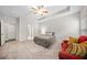 Bright bedroom with a tray ceiling, neutral carpet, and a seating area by the window at 110 Collingwood Lndg, Covington, GA 30016