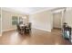 Bright dining room with hardwood floors, large window, modern lighting, and space for entertaining at 110 Collingwood Lndg, Covington, GA 30016