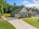View of long driveway leading to the attached two-car garage of this charming home at 110 Collingwood Lndg, Covington, GA 30016