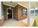 Inviting front porch with brick columns and well-maintained walkway at 110 Collingwood Lndg, Covington, GA 30016