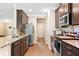 Modern kitchen with stainless steel appliances, granite countertops, and stylish dark wood cabinetry at 110 Collingwood Lndg, Covington, GA 30016