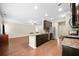 Open-concept kitchen with a granite island, stainless steel appliances, and hardwood flooring at 110 Collingwood Lndg, Covington, GA 30016