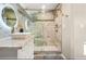 Stylish bathroom featuring marble tiling, glass shower and modern vanity at 1766 Ware Ave, Atlanta, GA 30344