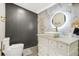 Luxury bathroom featuring modern fixtures, marble tiling, and white vanity at 1766 Ware Ave, Atlanta, GA 30344