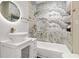 Updated bathroom featuring a modern vanity, sleek lighting, and tiled walls with gold accents at 1766 Ware Ave, Atlanta, GA 30344