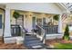 Inviting covered front porch with gray railings, potted plants, and a stylish front door at 1766 Ware Ave, Atlanta, GA 30344