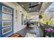 Relaxing front porch featuring a ceiling fan, seating, and a decorative multi-light front door at 1766 Ware Ave, Atlanta, GA 30344