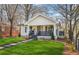 Charming home featuring a cozy porch and a beautifully landscaped front yard with lush green grass at 1766 Ware Ave, Atlanta, GA 30344