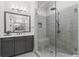 Bathroom featuring a glass enclosed shower with stone floor and gray vanity with white countertop at 205 Maplewood Dr, Roswell, GA 30075