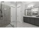 Bright bathroom featuring a glass enclosed shower, dual vanities and a neutral color palette at 205 Maplewood Dr, Roswell, GA 30075