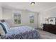 Bedroom with light gray carpet, dual windows with plantation shutters, and gray walls at 205 Maplewood Dr, Roswell, GA 30075