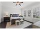 Bright bedroom featuring hardwood floors, two windows with plantation shutters, and neutral paint at 205 Maplewood Dr, Roswell, GA 30075