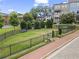 Well-maintained community green space with benches and black metal fencing for residents to enjoy at 205 Maplewood Dr, Roswell, GA 30075
