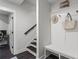 Entryway with a custom storage bench, coat hooks, and stairs leading to the upper level at 205 Maplewood Dr, Roswell, GA 30075