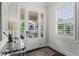 Bright foyer showcasing glass paned doors, hardwood floors, and white trim at 205 Maplewood Dr, Roswell, GA 30075
