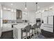 Bright kitchen featuring an island with seating, white cabinetry, and stainless steel appliances at 205 Maplewood Dr, Roswell, GA 30075