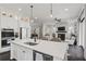 Kitchen featuring an island with a sink, stainless steel appliances, and white cabinetry at 205 Maplewood Dr, Roswell, GA 30075