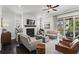 Cozy living room showcasing fireplace, hardwood floors, and comfortable seating at 205 Maplewood Dr, Roswell, GA 30075
