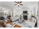 Bright living room with a fireplace, modern decor, and hardwood flooring at 205 Maplewood Dr, Roswell, GA 30075