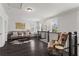 Spacious living room area with dark hardwood floors, lots of bright, natural light, and neutral colored walls at 205 Maplewood Dr, Roswell, GA 30075