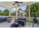 Covered outdoor patio with outdoor seating, grilling area, and green surroundings at 205 Maplewood Dr, Roswell, GA 30075